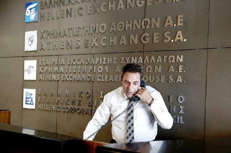 An employee works on the Athens Stock Exchange in Greece on Monday.