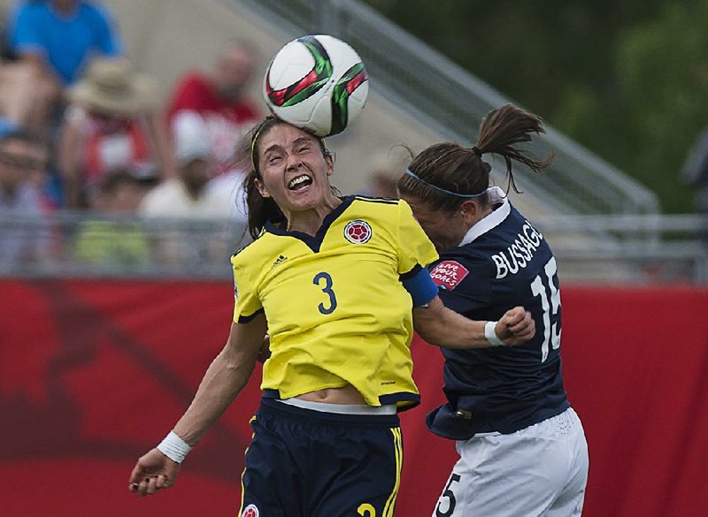 Colombia’s Natalia Gaitan heads the ball June 13 against France’s Elise Bussaglia during a Women’s World Cup soccer game in Moncton, New Brunswick, Canada.