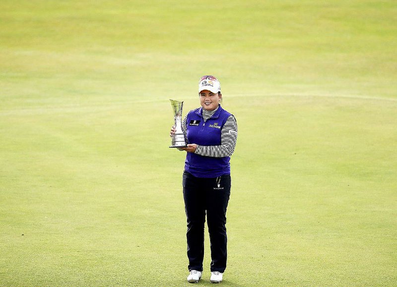 Inbee Park of South Korea poses with the trophy Sunday after winning the Women's British Open golf championship at Turnberry, Scotland.