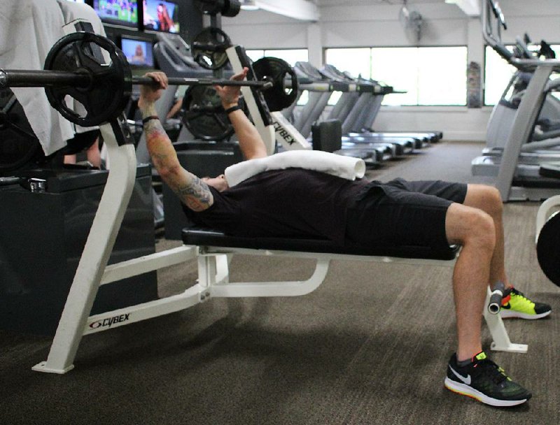 David S. Martinous uses a folded towel instead of a half foam roller as he does step 1 of the Foam Roller Bench Press.