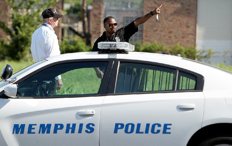 Memphis police canvass an area Sunday near where police officer Sean Bolton was fatally shot during a traffic stop Saturday night in Memphis.