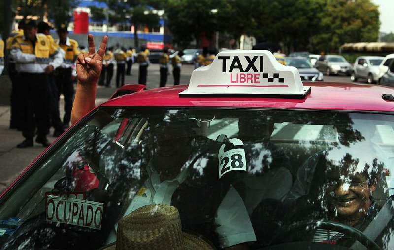 Street taxi drivers protest against the smartphone-based ride service Uber in Mexico City last week. The Mexican taxi drivers’ union called for a protest against unlicensed and Uber taxis working in the city.