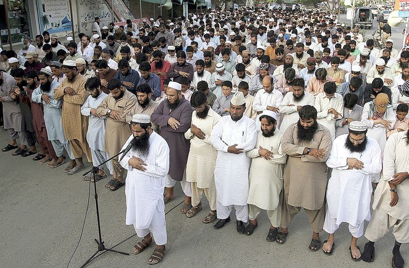 Supporters of Jamaat-ud-Dawa, a hard-line Islamist group in Pakistan, offer funeral prayers for Taliban leader Mullah Mohammad Omar outside a mosque in Karachi, Pakistan, on Sunday.