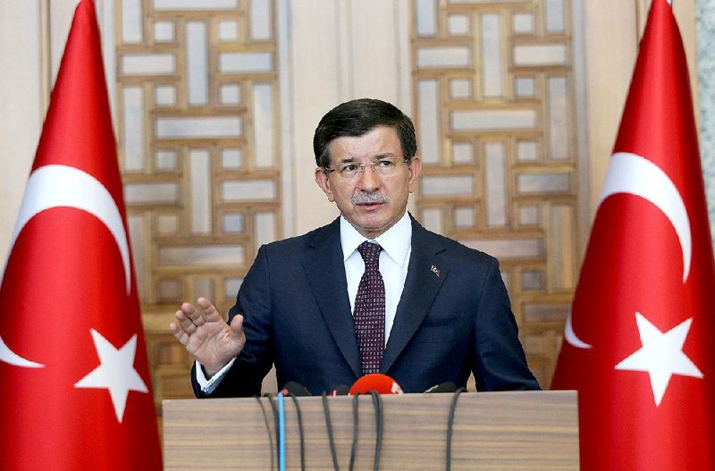 Turkish Prime Minister Ahmet Davutoglu speaks to the media in Ankara, Turkey, on July 24.