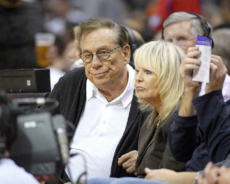In this Nov. 7, 2012, file photo, Los Angeles Clippers owners Donald Sterling, left, and his wife Shelly Sterling watch the Clippers play the San Antonio Spurs during an NBA basketball game in Los Angeles. The former team owner has filed for divorce from Shelly Sterling, his attorney Bobby Samini said Wednesday, Aug. 5, 2015. 