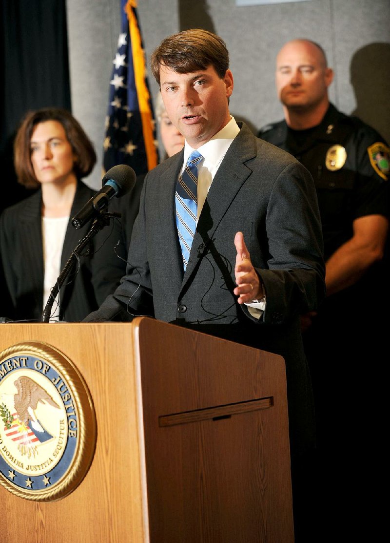 Conner Eldridge, U.S. attorney for the Western District of Arkansas, speaks Wednesday alongside law enforcement officers and school representatives to announce the implementation of the Arkansas Defending Childhood initiative at the Washington County sheriff’s office in Fayetteville. The program would inform school districts when officers encounter children during violent, criminal or traumatic events.  