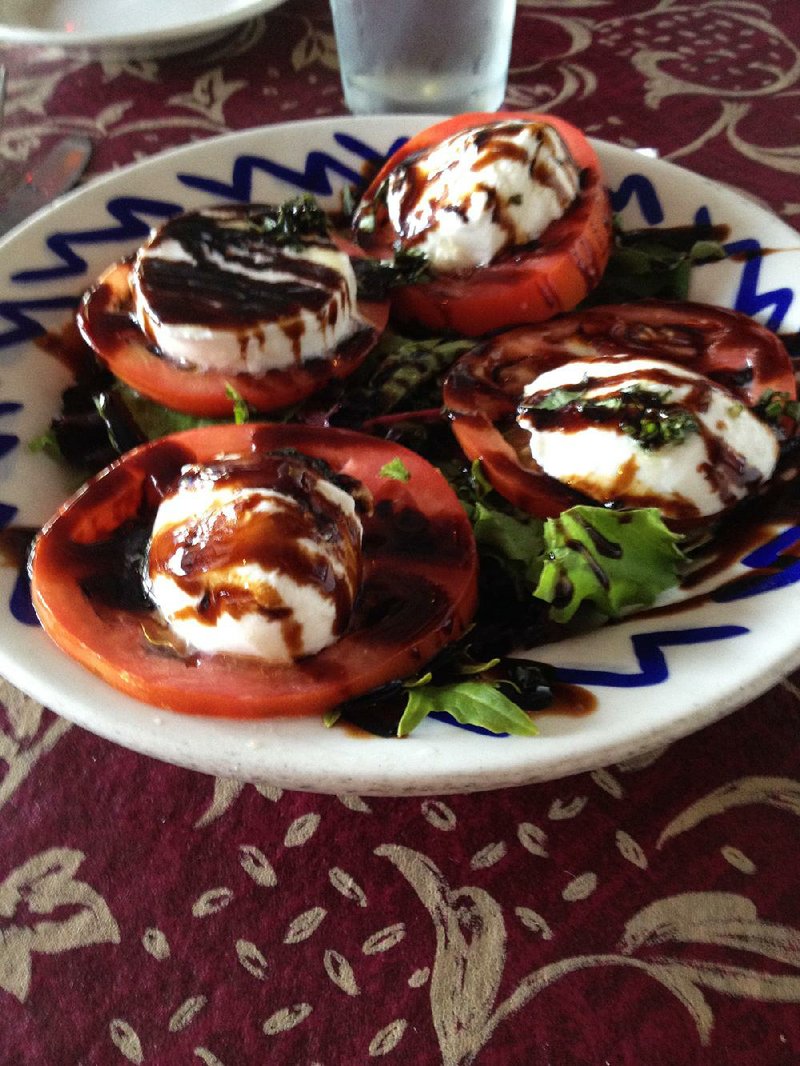 Balasmic vinegar accents fresh mozzarella, fresh tomatoes and fresh basil in Cafe Prego’s Caprese salad. 