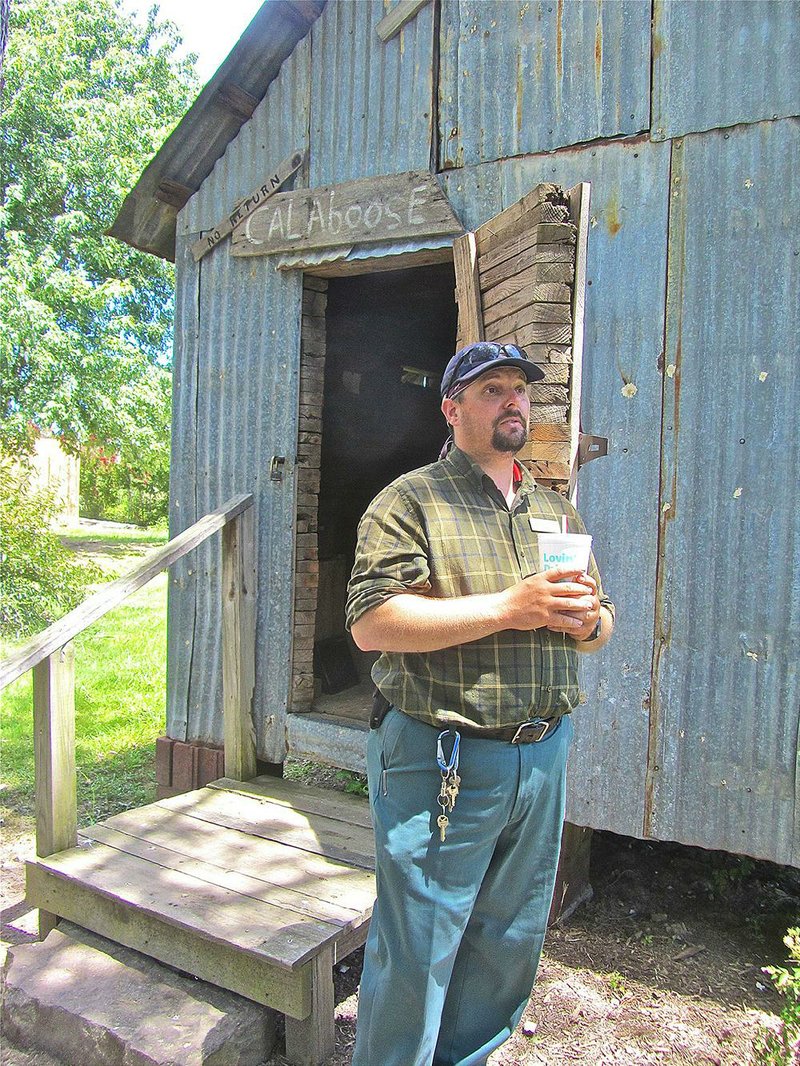 Guide Justin Gehring describes the features of the old Pangburn Community Jail at White County Pioneer Village in Searcy. 
