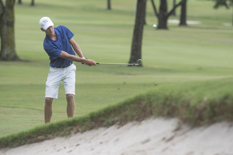 NWA Democrat-Gazette/J.T. WAMPLER Jackson Marseilles of Harrison makes a chip shot on hole four Wednesday in the Springdale Bulldog Invitational at the Springdale Country Club.