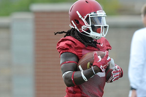 Arkansas running back Alex Collins goes through practice Thursday, Aug. 6, 2015, in Fayetteville. 