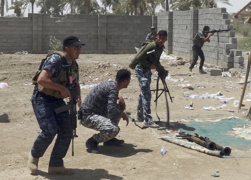 NW Iraqi security forces backed by Shiite and Sunni pro-government fighters clash Tuesday with Islamic State militants at the front line in the eastern suburb of Ramadi. 