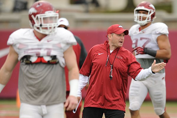 Robb Smith, Arkansas defensive coordinator, speaks to his players during practice Saturday, April 18, 2015, at the university's practice facility in Fayetteville.