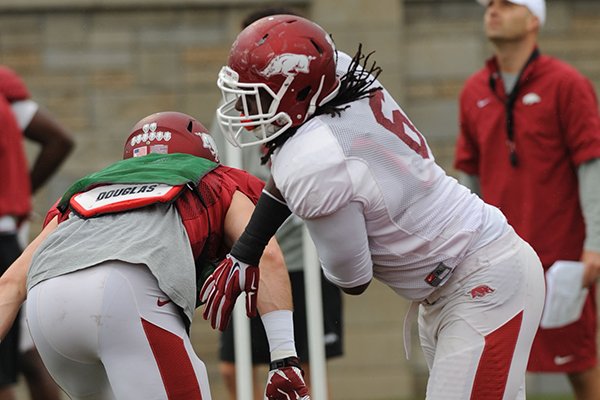 Arkansas defensive end JaMichael Winston works through a drill during practice Saturday, April 18, 2015, at the university's practice facility in Fayetteville.