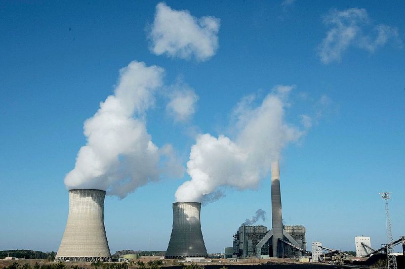 The smokestack (right) at the coal-fired White Bluff power plant near Redfield sends up a column of smoke as steam rises from the plant’s cooling towers in this 2009 photo. 