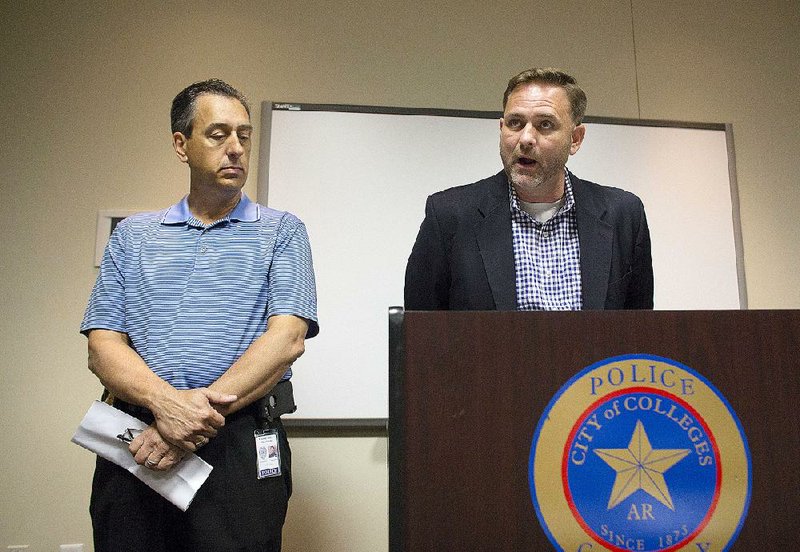 Conway Police Chief A.J. Gary, left, and Prosecuting Attorney Cody Hiland, right, speak to media during a press conference at Conway Police Station in downtown Conway August 7, 2015. 