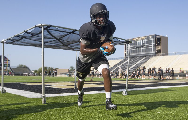 Elijah Barnett, Bentonville senior defensive back, catches a ball Friday during positions drills at the Tiger Athletic Complex in Bentonville.