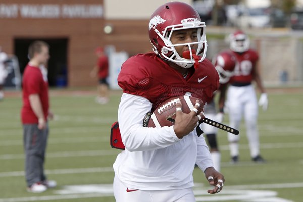 Arkansas wide receiver Jared Cornelius makes a reception during practice in Fayetteville April 21, 2015.