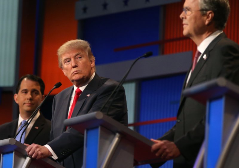 Republican presidential candidate Donald Trump looks toward Jeb Bush (right) as Scott Walker watches Thursday during the first Republican presidential debate at the Quicken Loans Arena in Cleveland. 