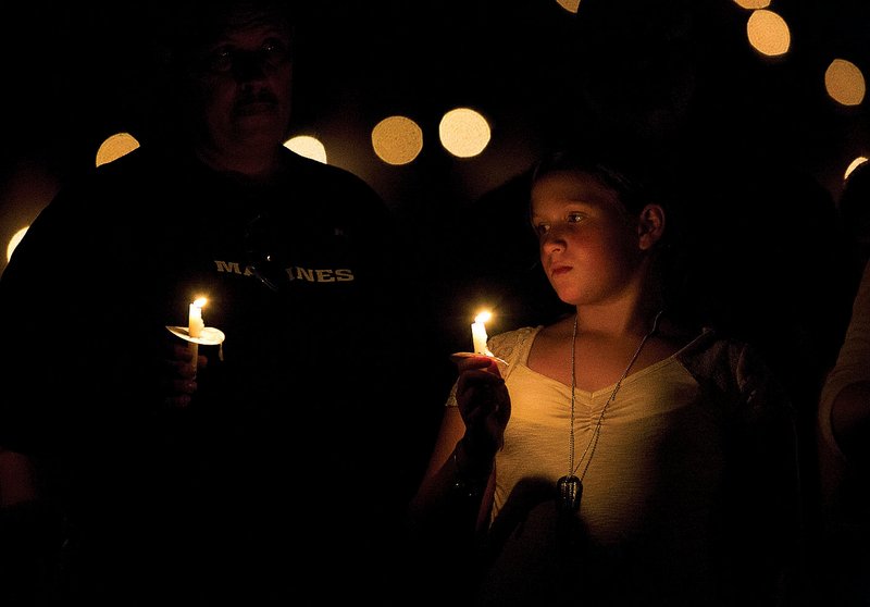 Rebecca Wyatt attends a vigil Friday night at Russellville High School that honored her father, Marine Staff Sgt. David Wyatt, who was slain July 16 in attacks on military facilities in Chattanooga, Tenn.