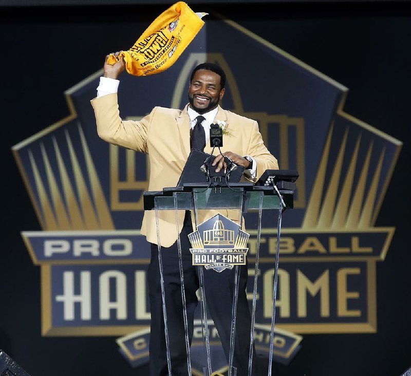 Jerome Bettis waves a Terrible Towel at the conclusion of his speech after being inducted into the Pro Football Hall of Fame on Saturday night in Canton, Ohio. 