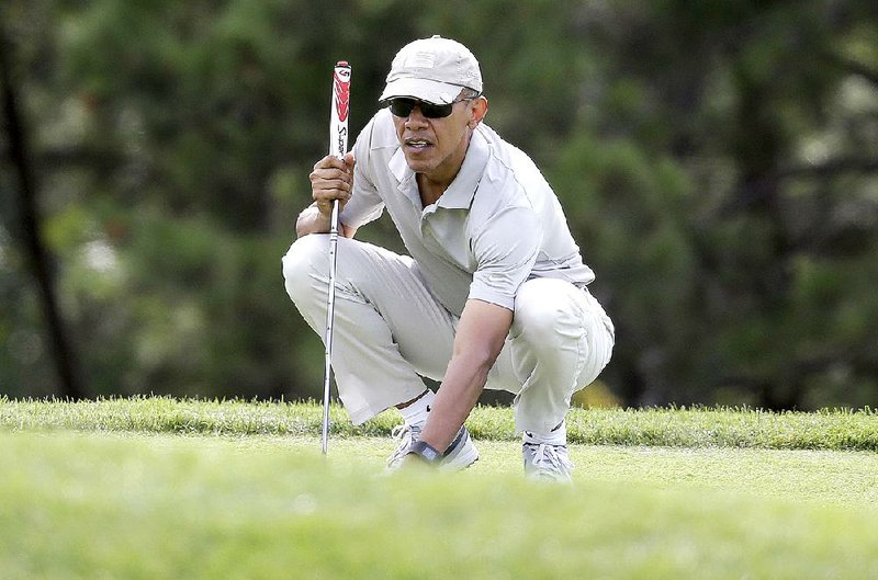 President Barack Obama lines up a putt Saturday on a course at Oak Bluffs, Mass., on Martha’s Vineyard island. In a CNN interview airing today, Obama said that resolving the Iranian nuclear issue makes it possible to open broader talks with Iran. 