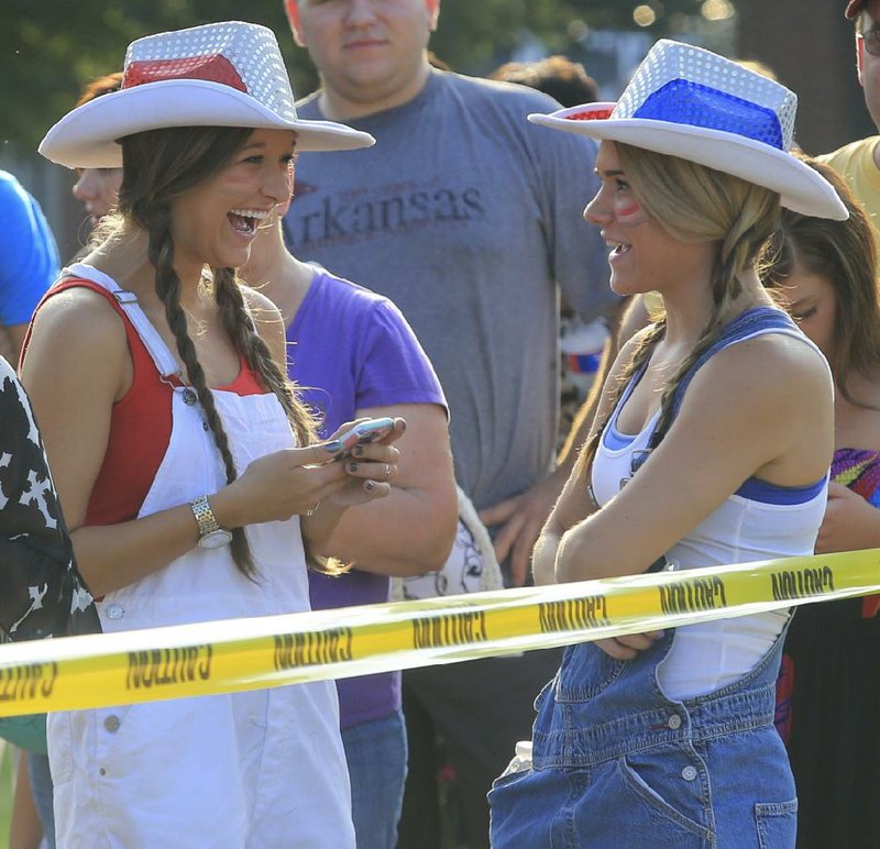 Contestants Hannah Shoemaker (left) and Eden McGhee, both 18, wait outside Verizon Arena in North Little Rock on Saturday morning to audition for the 15th season of the singing competition show American Idol. See more photos at arkansasonline.com/galleries.