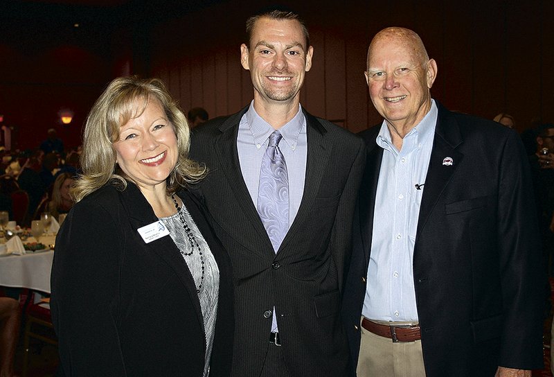 Kembra Mathis (from left), Brendon McDermott and Dean Weber, Kendrick Fincher Hydration Foundation board members, welcome guests to the Beat the Heat luncheon.