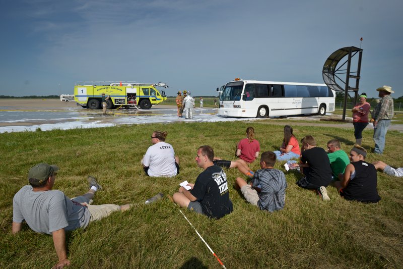 Volunteer casualties wait for treatment Saturday during a full-scale training exercise at Northwest Arkansas Regional Airport in Highfill. The exercise for agencies in Benton County that respond to emergencies at the airport simulated a plane crash scenario. For more photos, go to www.nwadg.com/photos.