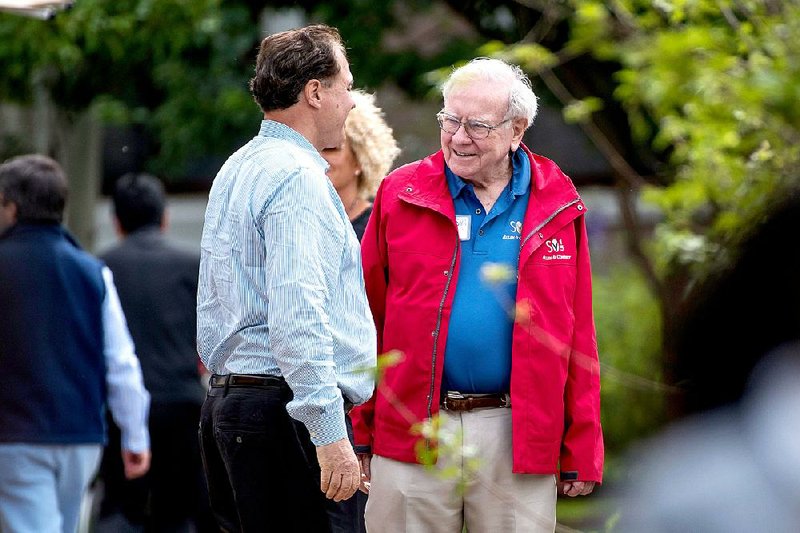 Warren Buffett, chairman and chief executive officer of Berkshire Hathaway Inc. (right), stops to talk with an attendee at the Allen & Co. Media and Technology Conference in Sun Valley, Idaho, in July.