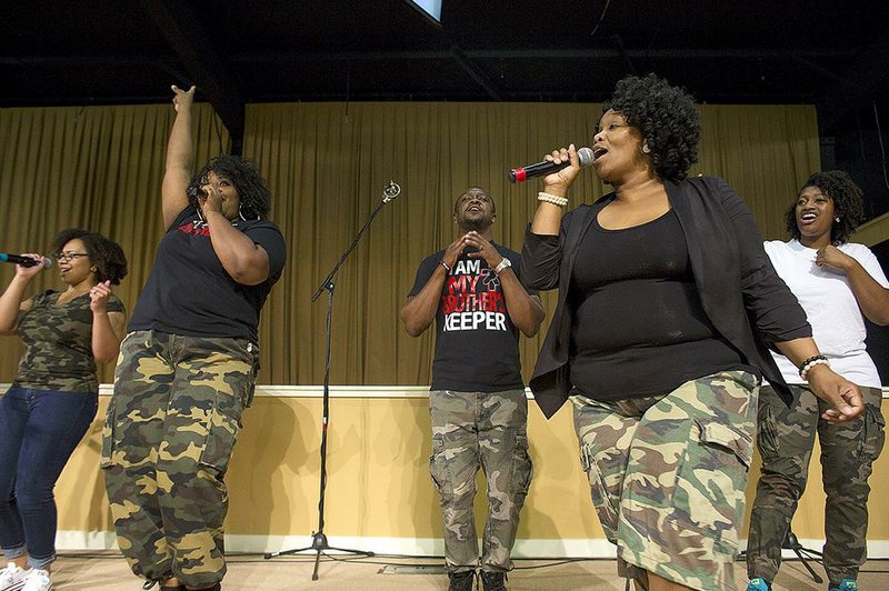 LaTaveya Franklin (front) sings with the Grace Temple Young Adult Choir on Sunday at Grace Temple Church in Little Rock during a Stop the Violence gathering.