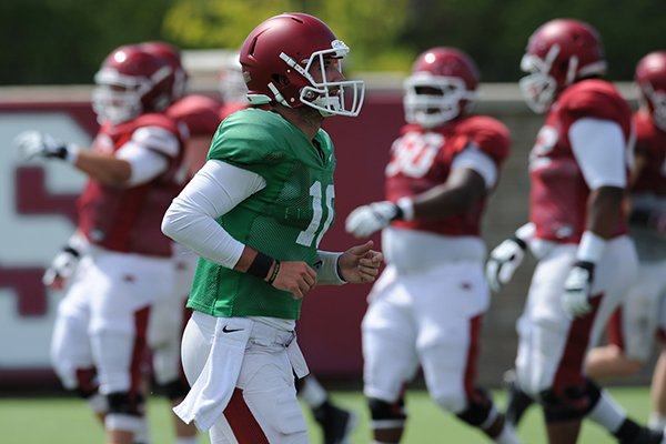 Arkansas quarterback Brandon Allen returns to the huddle Tuesday, Aug. 11, 2015, during practice at the university's practice field in Fayetteville.