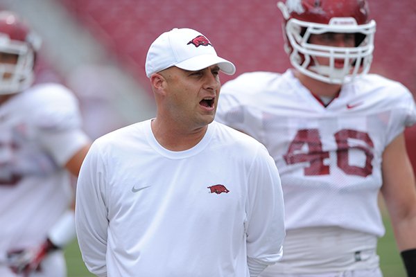 Arkansas tight ends coach Barry Lunney Jr. directs his players during practice Saturday, Aug. 16, 2014, at Razorback Stadium in Fayetteville.