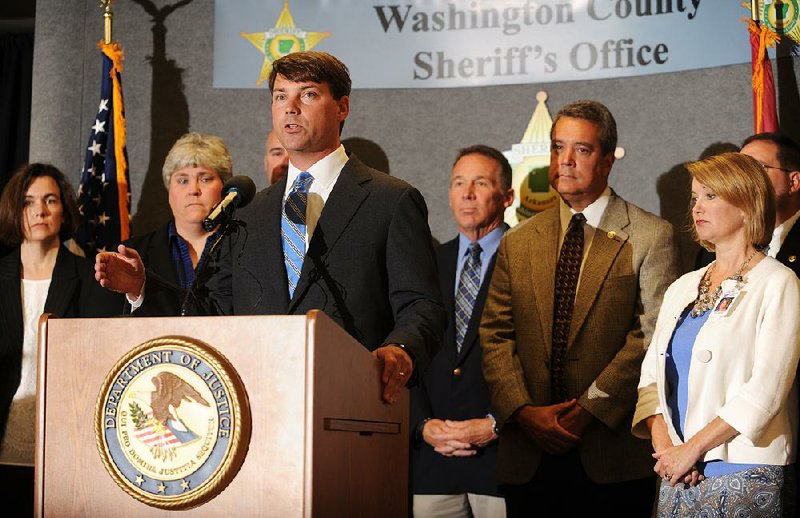 Conner Eldridge, U.S. Attorney for the Western District of Arkansas, speaks Wednesday, Aug. 5, 2015, alongside law enforcement and area school representatives to announce the implementation of the Arkansas Defending Childhood Initiative at the Washington County Sheriff's Office in Fayetteville.