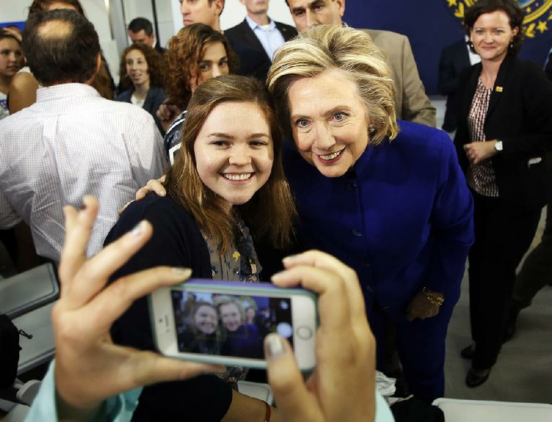 Hillary Rodham Clinton poses for a picture Tuesday during a campaign stop at River Valley Community College in Claremont, N.H. The Democratic presidential candidate is cooperating with an FBI investigation into her emails while secretary of state, a campaign spokesman said Tuesday night. 