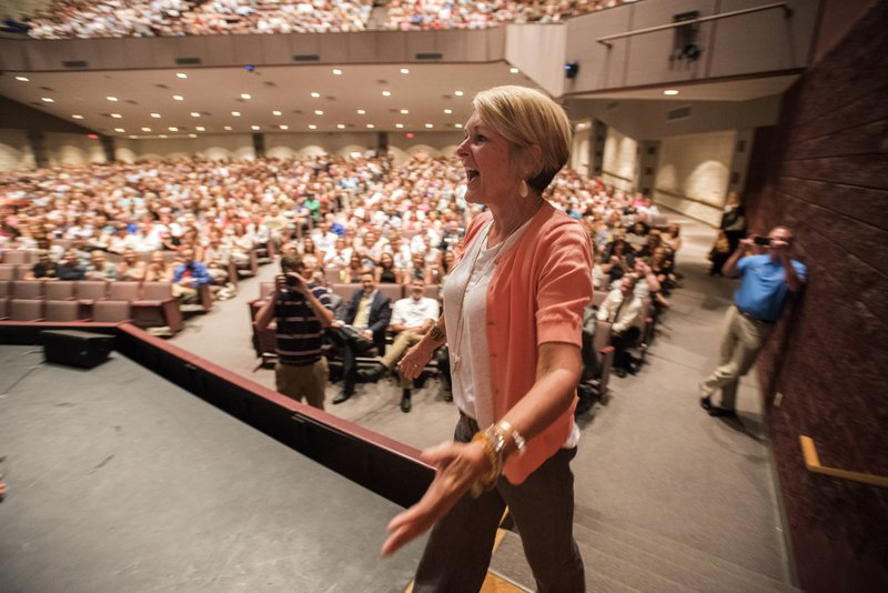 NWA Democrat-Gazette/J.T. WAMPLER Jamie Woods, a teacher at Central Junior High School, takes the stage Tuesday to claim her prize of a one-year free lease for a Jeep from a local dealership. The prize was announced during the annual Back to School meeting of all Springdale teachers, principals and district leaders. The event included remarks by Superintendent Jim Rollins, Education Commissioner Johnny Key, Arkansas State Chamber of Commerce President Randy Zook and Don Siviski from the Center for Secondary School Reform.