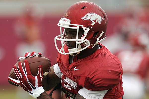 Jojo Robinson of Arkansas works through a drill during practice Saturday, April 18, 2015, at the university's practice facility in Fayetteville.
