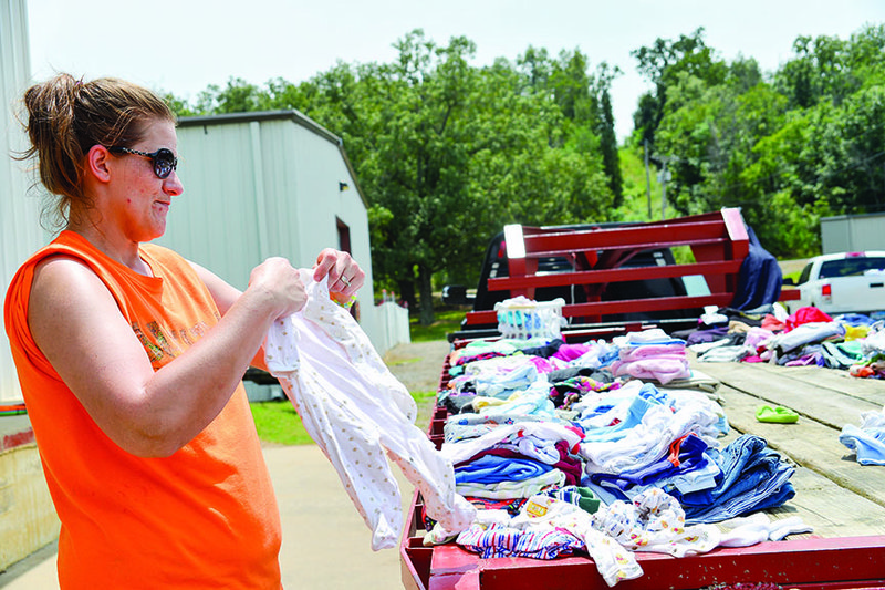 Pam Snyder of Morrilton uses a flatbed truck to display all the clothes she had for sale during the 2014 Bargains Galore on 64. This year’s event is scheduled for this weekend. 