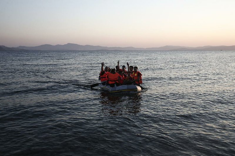 A dinghy with foreigners arrives at the Greek island of Kos on Wednesday after crossing the Aegean Sea from Turkey. 