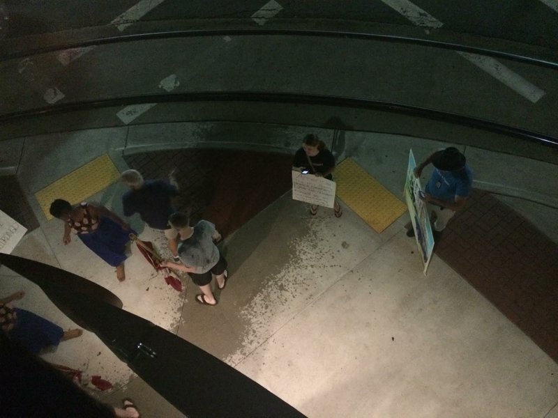 The head chef and owner of Cache in downtown Little Rock poured a bucket of water on a small group of protesters Wednesday night, hitting one. Photo courtesy Stephanie Maxwell.