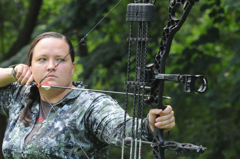 NWA Democrat-Gazette/FLIP PUTTHOFF Hannah Cicioni practices Aug. 6 to prepare for her western elk hunting adventures. Cicioni shoots dozens of arrows each day to get ready for her solo archery elk hunts.
