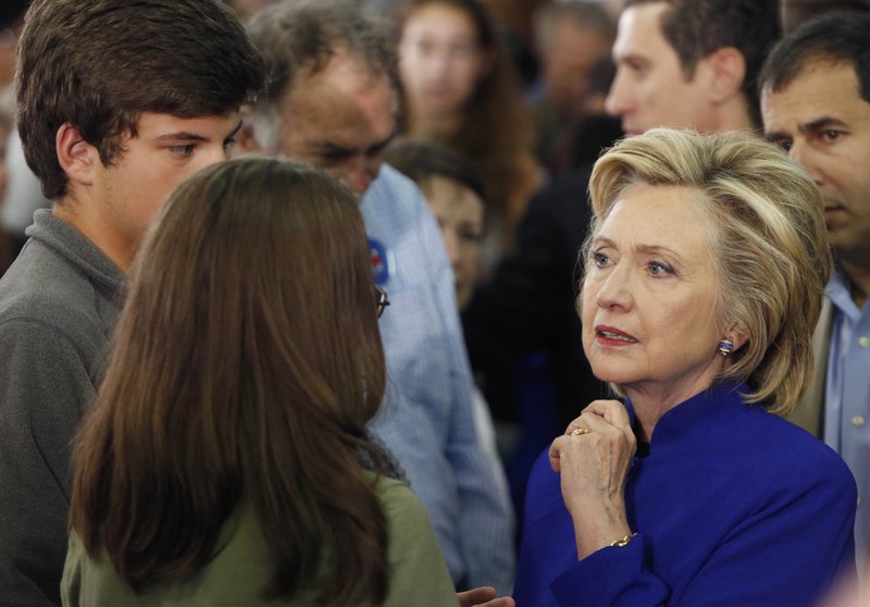  In this Aug. 11, 2015 file photo, Democratic presidential candidate Hillary Rodham Clinton listens as she meets with voters during a campaign stop at River Valley Community College in Claremont, N.H.