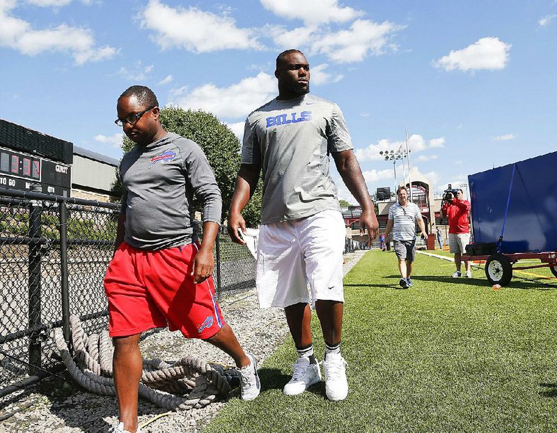 Buffalo Bills linebacker Ikemefuna Enemkpali (right) apologized Thursday for injuring New York Jets quarterback Geno Smith. Enemkpali was released by the Jets on Tuesday and was claimed off waivers by the Bills on Wednesday.