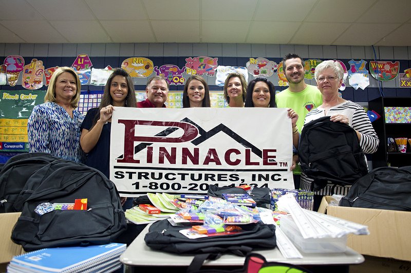 Pinnacle Structures and Arkansas Office Products teamed up this year to provide backpacks and school supplies for 50 students at Ward Central Elementary School. From left are Charon Regnas, Nicole Singleton and Steven Pawloski, all of Arkansas Office Products; Nancy Bard of Pinnacle Structures; Dawn Verkler, principal of Ward Central Elementary; Courtney Jackson of Pinnacle Structures; Andy Sullivan of Ward Central Elementary; and Pam Griffin of Pinnacle Structures.