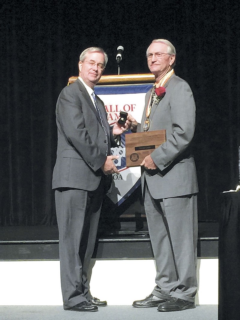 Ronnie Carter, right, of Hot Springs receives his awards for being named as one of the 2015 inductees of the Arkansas High School Athletic Administrators Association Hall of Fame earlier this summer. Carter retired from coaching and teaching in 2008 after finishing his career in the Hot Springs School District. Carter also spent time in the Monticello, Lonoke, Magnolia and Russellville school districts, as well as in Georgia. 