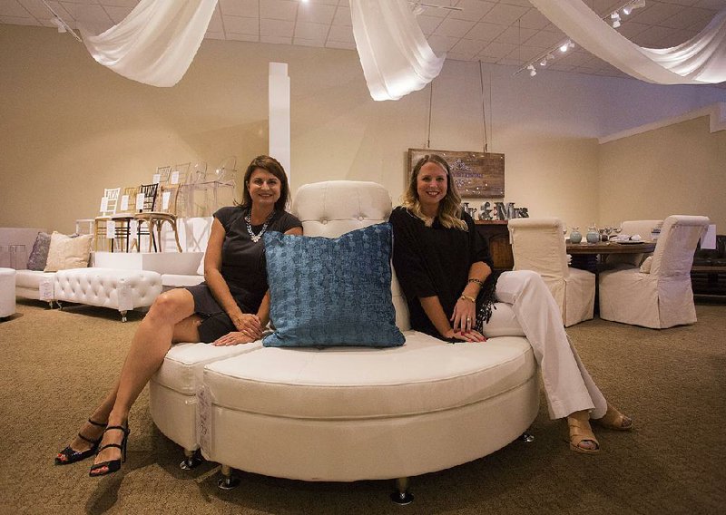 Mary Browne Allen (left) and Charla Boatright sit on a round banquette that is available for renting at Hank’s Event Rentals. Hank’s rents sofas, tables and chairs, bars and other items for parties and weddings.