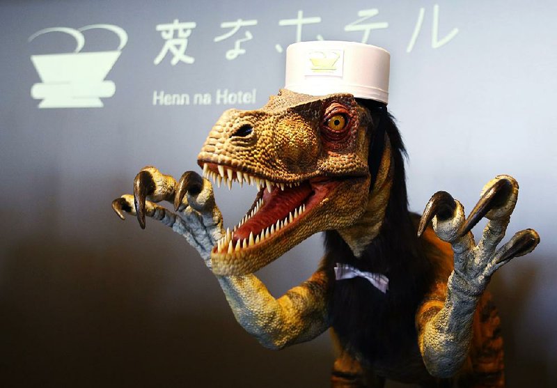 A receptionist dinosaur robot performs at the new robot hotel, aptly called Henn na Hotel or Weird Hotel, in Sasebo, southwestern Japan. 