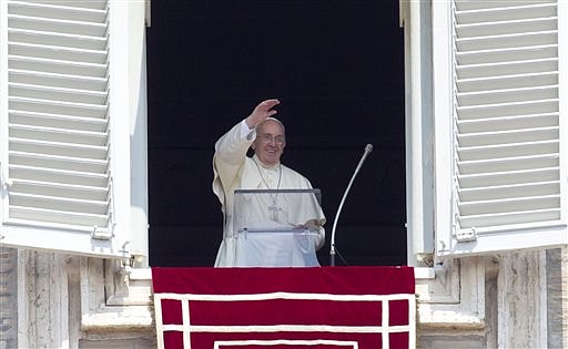 The Associated Press BELIEFS MEET POLITICS: Pope Francis waves to the faithful as he arrives to recite the Angelus noon prayer from his studio window overlooking St. Peter's Square at the Vatican last Sunday.