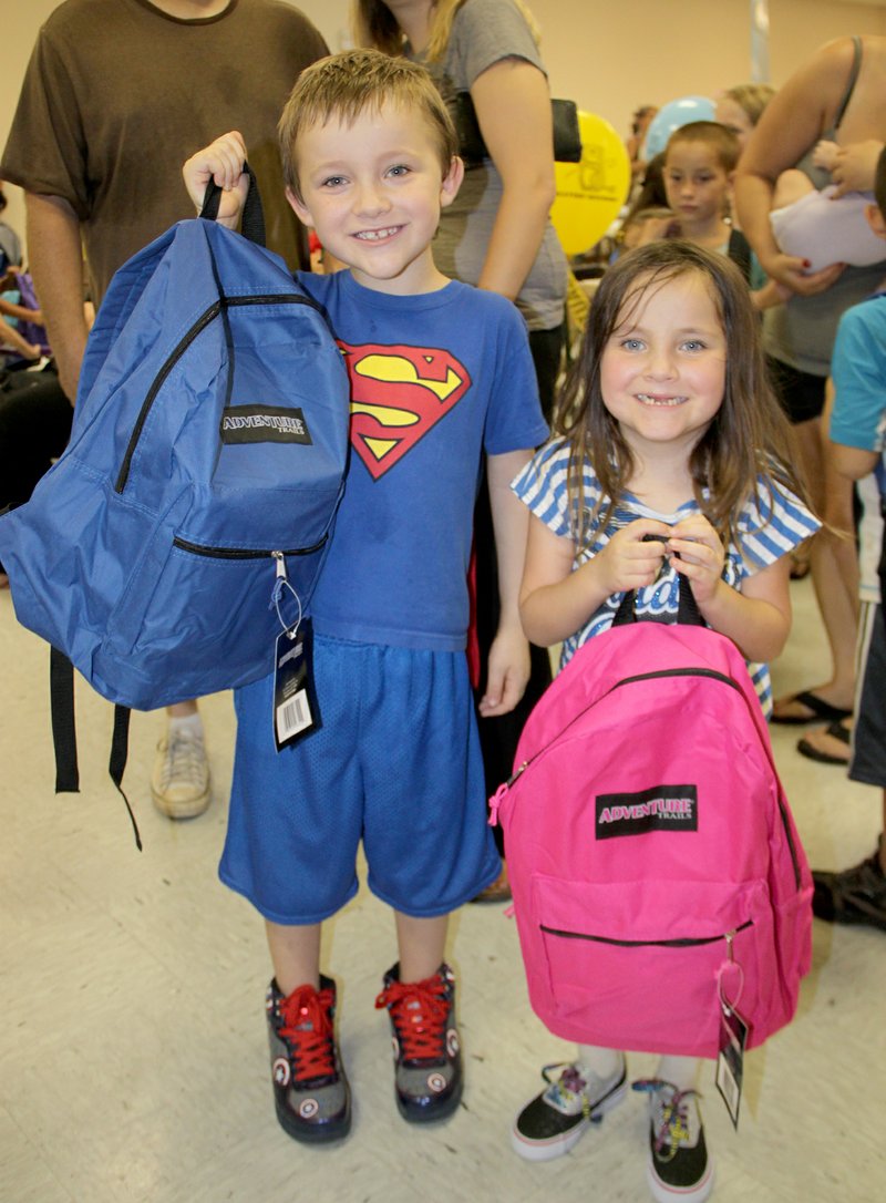 Taylor Doss, 7, and his sister, Sabrina Doss, 6, of Lincoln, were excited to show off their new bright colored backpacks for school. Taylor also picked out a pair of new Captain America tennis shoes. Taylor and Sabrina will be ready for a new school year, along with 200 other children in the Lincoln Area. The sixth annual Lincoln Back to School Bonanza was another success, said Gary Lunsford, pastor of Central United Methodist Church. 