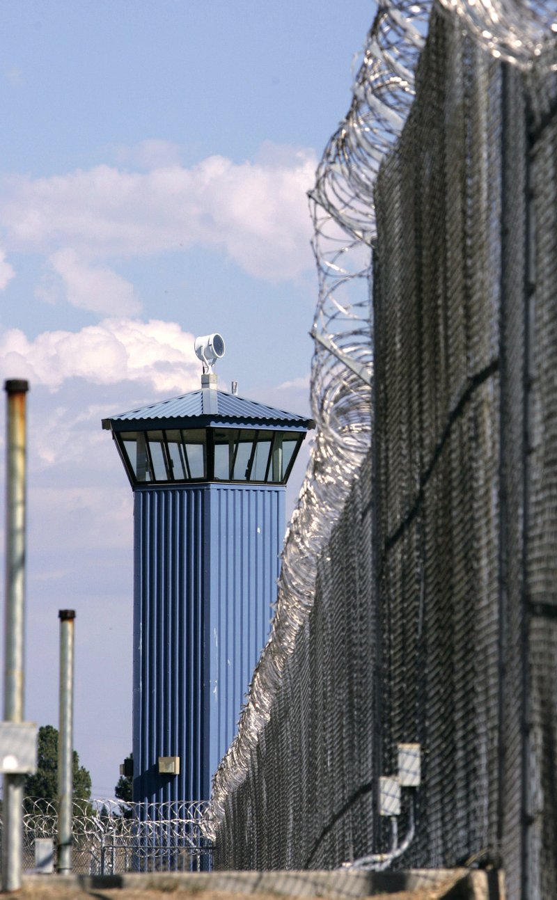 In this file photo, a guard tower stands behind the wire fence that surrounds California State Prison, Sacramento, in Folsom, Calif.  Corrections officials say one inmate is dead and several others have been taken to an outside hospital to be treated for stab winds after a riot broke out at one of the prison's exercise yard, Wednesday, Aug. 12, 2015.