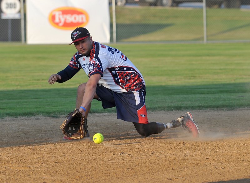 NWA Democrat-Gazette/MICHAEL WOODS @NWAMICHAELW Wounded Warrior Amputee Softball short stop Saul Bosquez makes a play on a ground ball during their softball game Friday against the Tyson Al-Stars at the Tyson Complex in Springdale.
